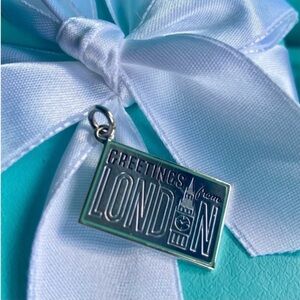 Tiffany & Co. New, sterling silver post card charm “Greetings from London”.